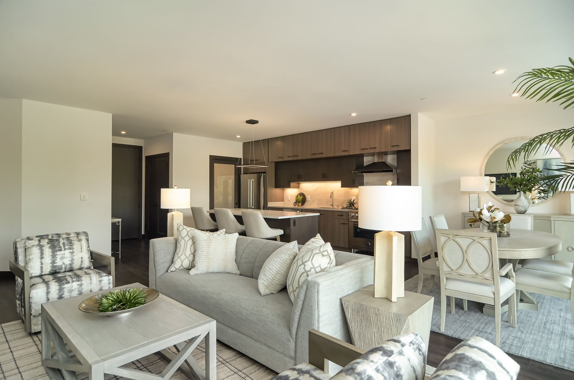 Open-concept living space with gray sofa, kitchen, dining area, and neutral decor at Ventana Apartments in Wayzata, MN.