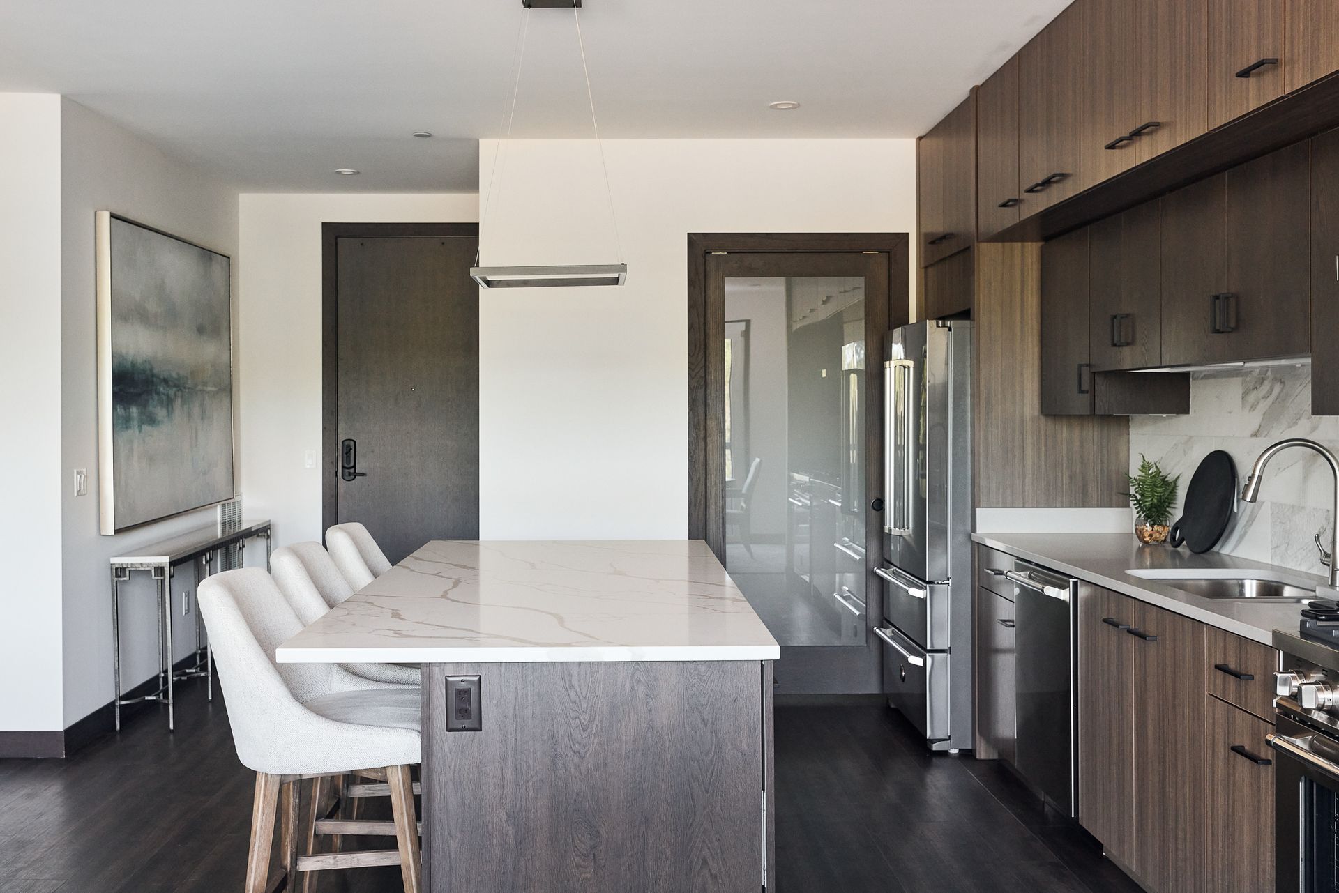Modern kitchen with wood cabinets, island, and stainless steel appliances at Ventana Apartments in Wayzata, MN.