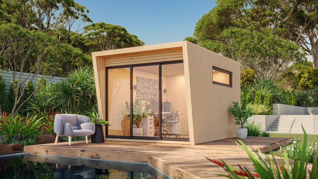 Wooden Backyard Office With Large Glass Doors, Small Window, and Grey Armchair Near a Pool — Designer Building Pty Ltd In Charmhaven, NSW