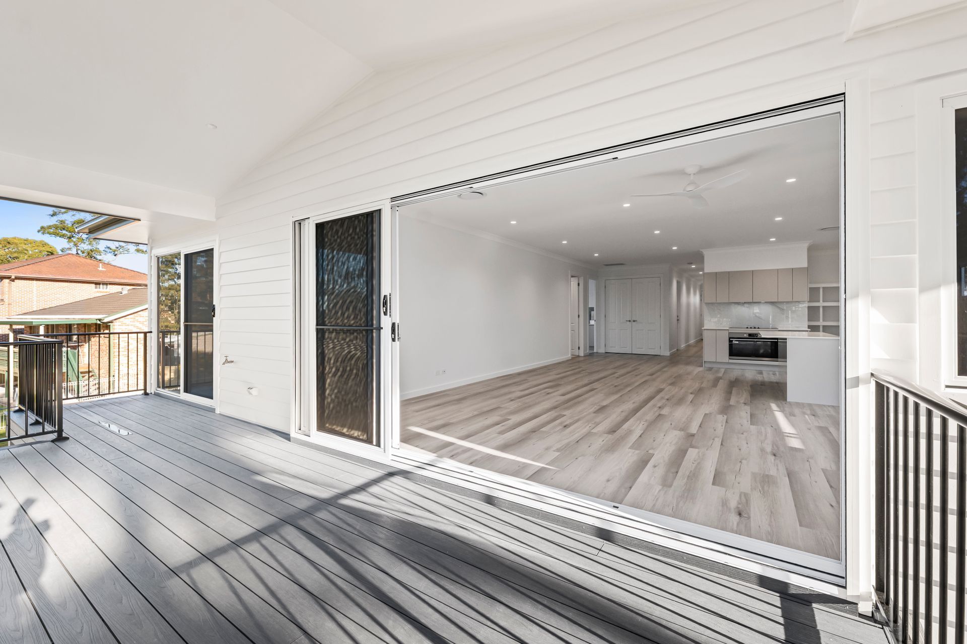 Open Sliding Doors Reveal a Modern Interior from A Gray-Decked Porch — Designer Building Pty Ltd In Wyong, NSW