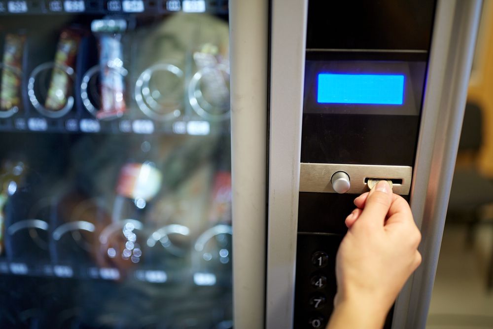 A Person is Using a Vending Machine to Buy Food — Central Coast Storage Solutions in Coffs Harbour, NSW