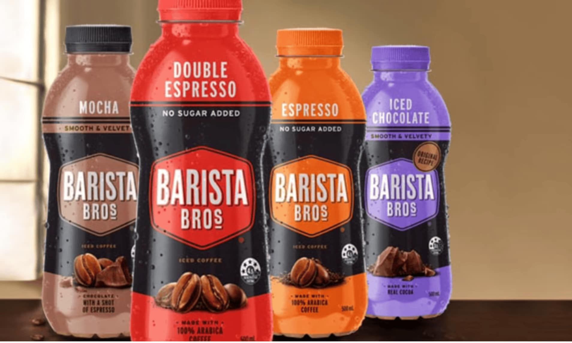 Four Bottles of Barista Bros Coffee Are Lined Up on a Table — Central Coast Storage Solutions in Toormina, NSW