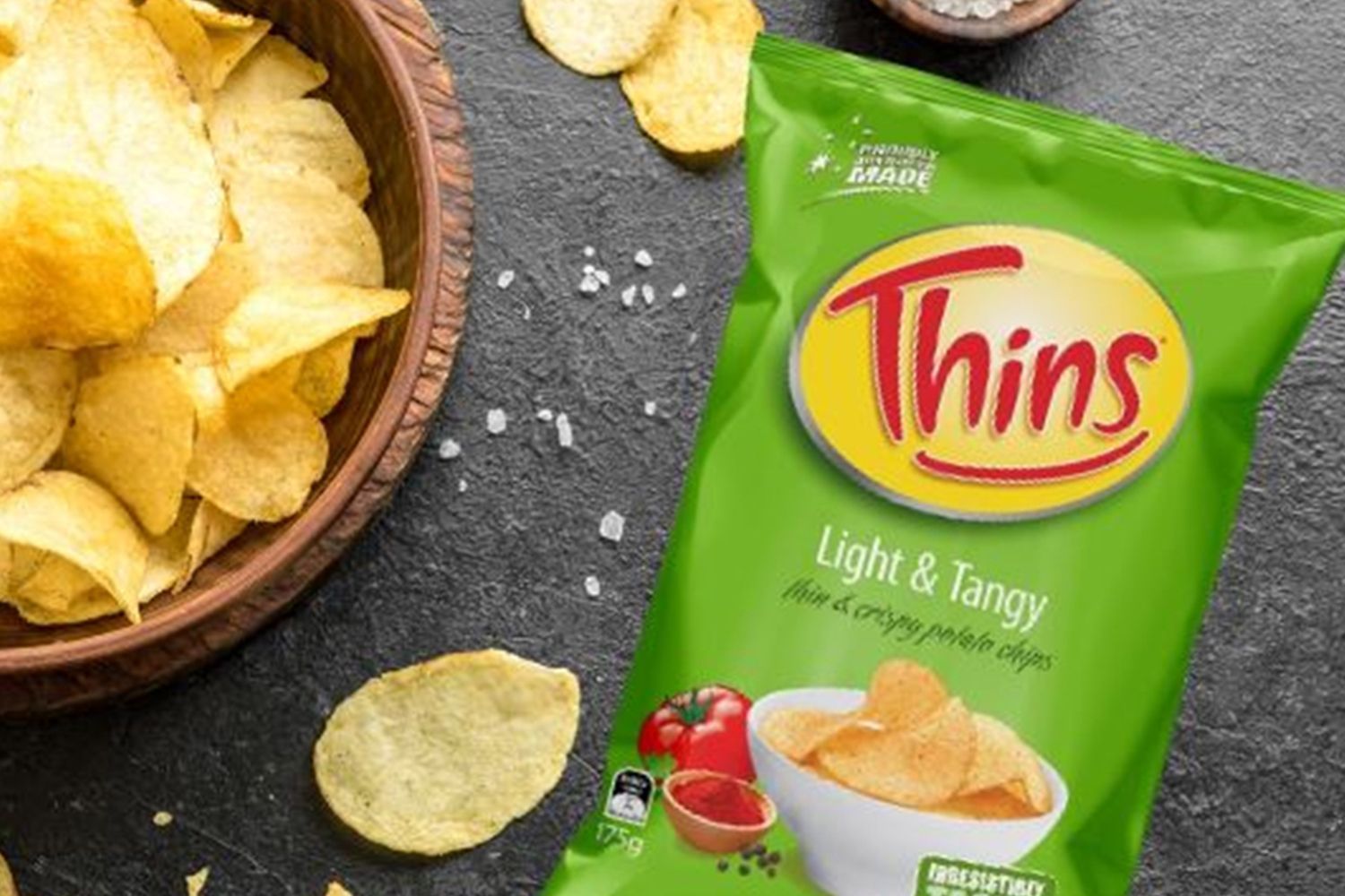 A Bag of Thins Chips is Sitting Next to a Bowl of Chips — Central Coast Storage Solutions in Toormina, NSW
