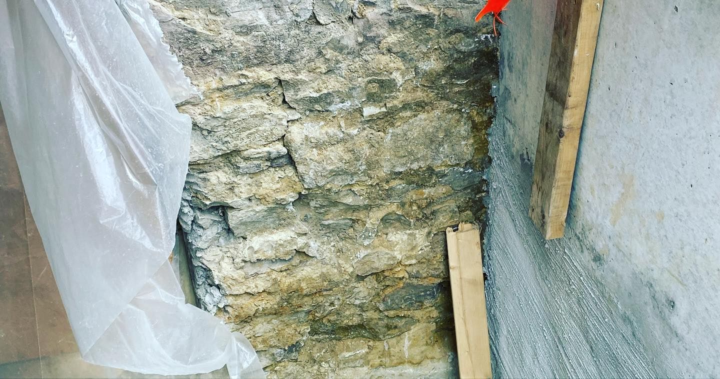 A close up of a stone wall with a plastic bag covering it.