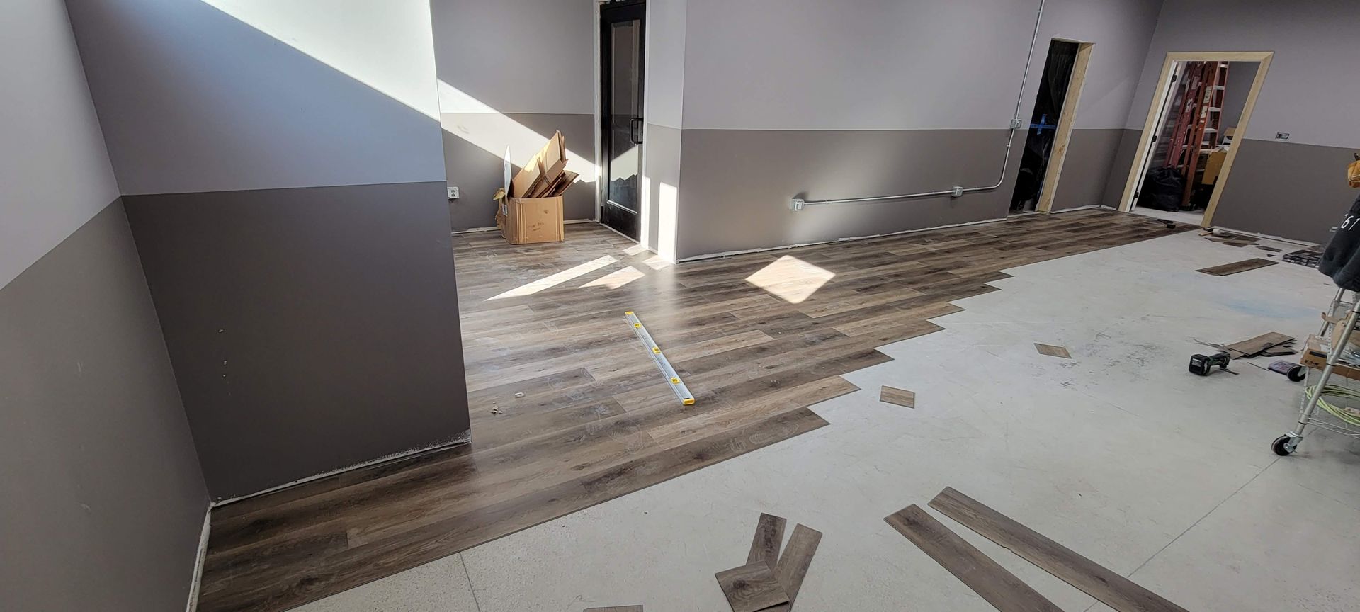 Abandoned hallway with debris and broken flooring in a damaged building interior