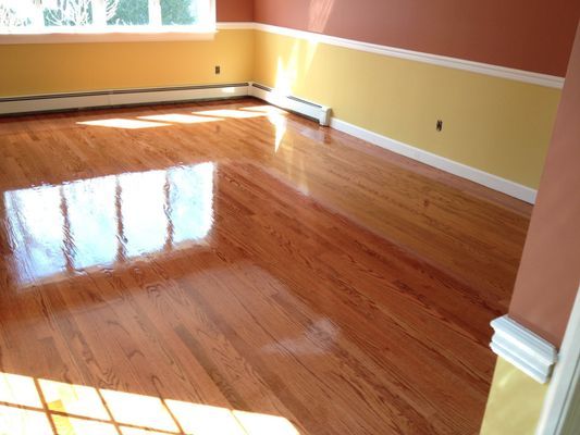 A living room with hardwood floors and yellow walls