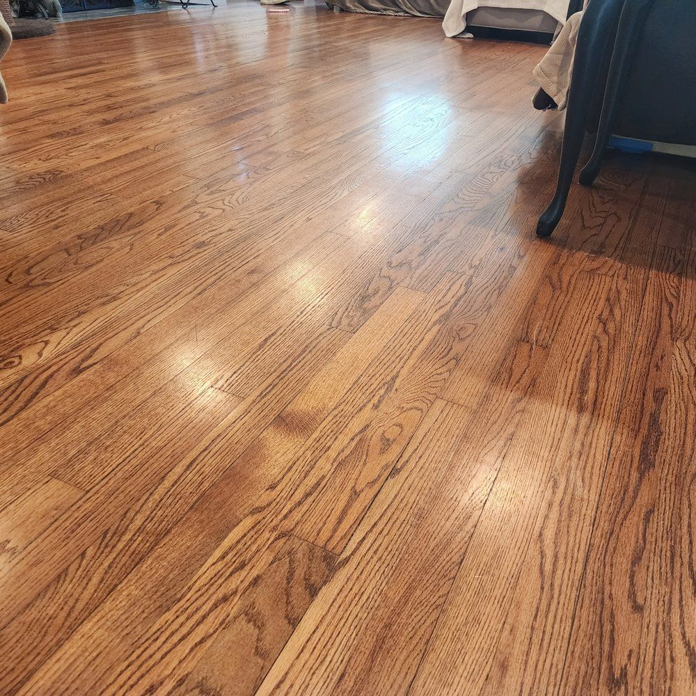 A close up of a wooden floor in a living room.