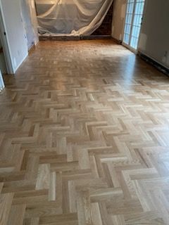 A room with hardwood floors and tile floors