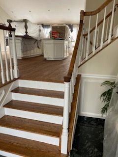 A staircase with wooden steps and a white railing in a house.