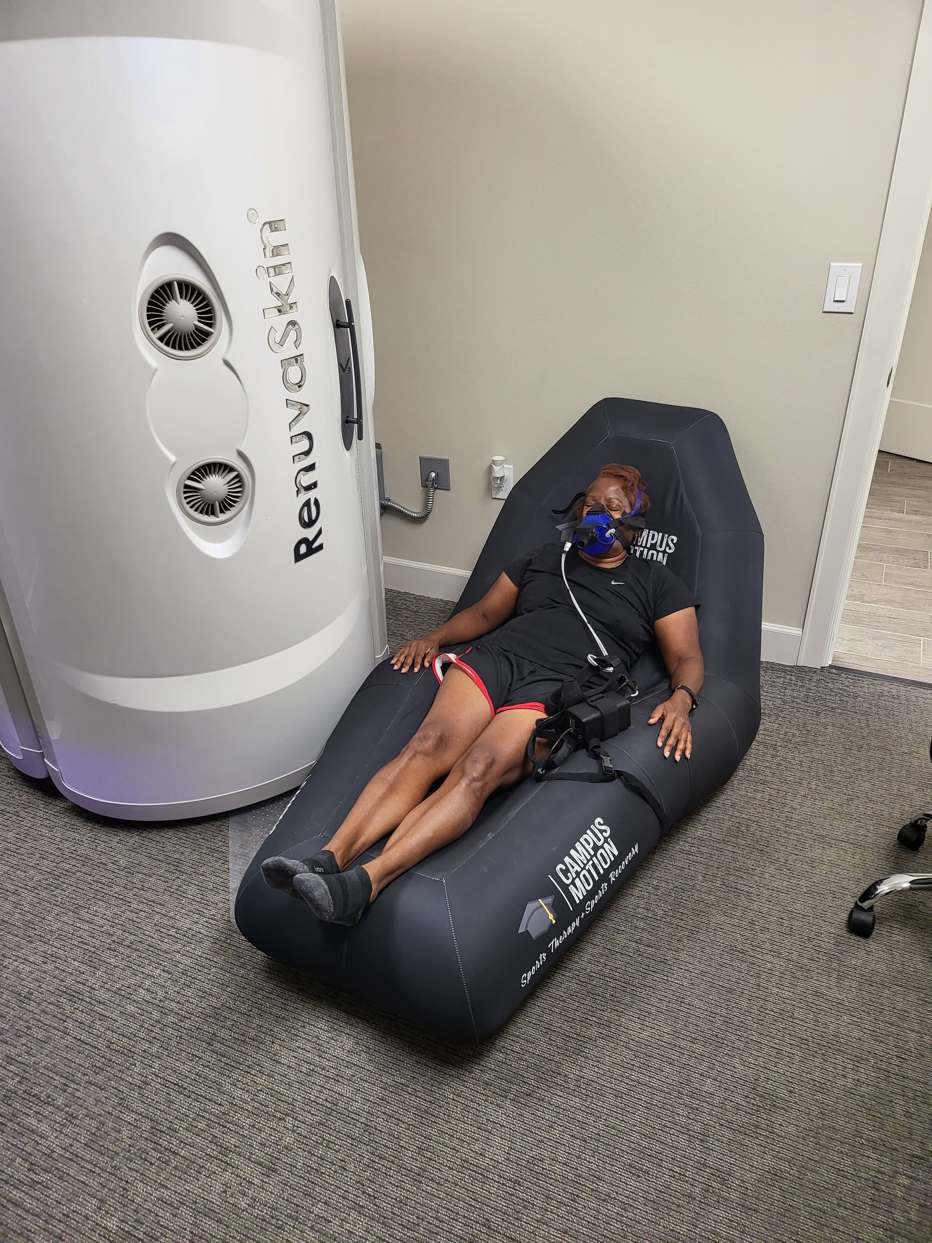A woman at rest during RMR testing, contributing to Optimized Weight Management. This test provides precise calorie intake recommendations based on her resting metabolic rate, simplifying the process of achieving and maintaining her desired weight and promoting sustainable results.