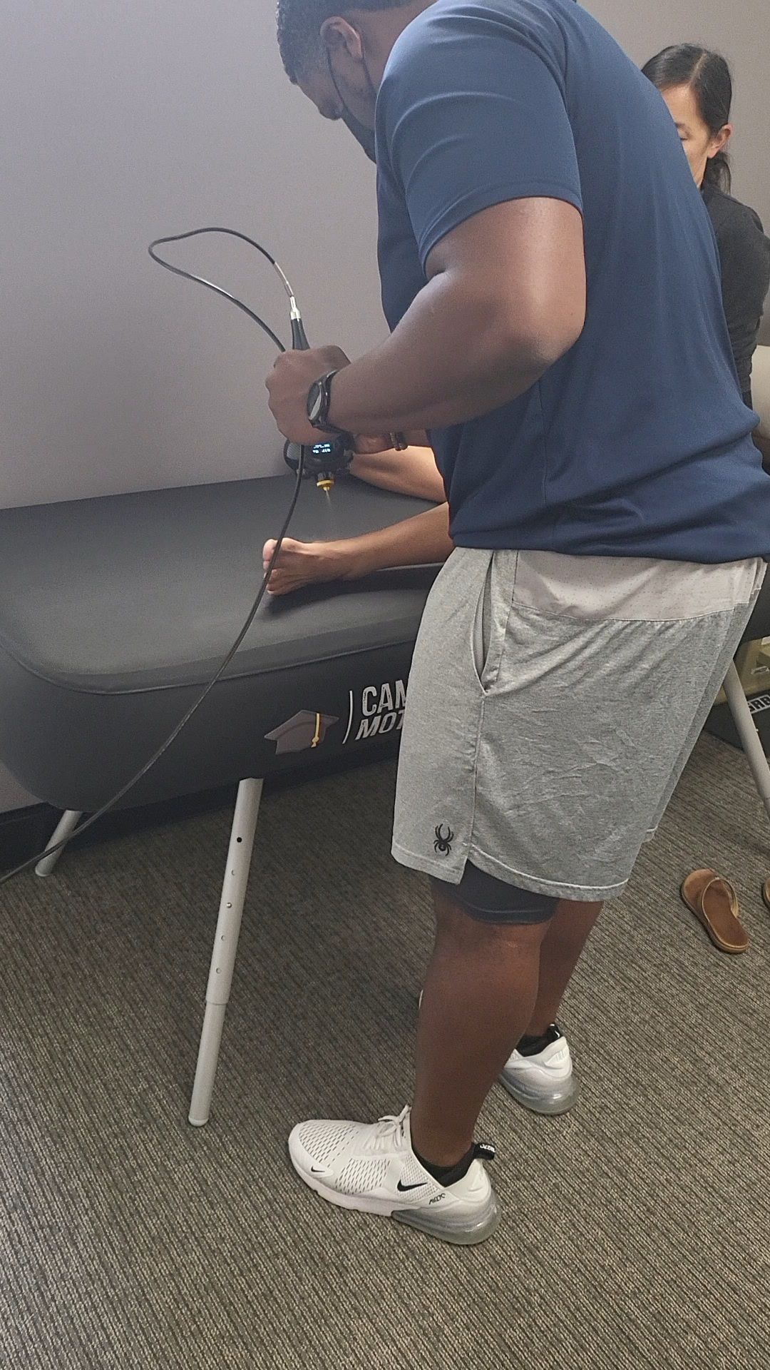 A woman standing still in front of the 3D cameras of KinetiSense during a balance screening. This technology aids in creating a Tailored Treatment plan by identifying specific balance issues and symptoms, which accelerates recovery and reduces the risk of long-term complications.