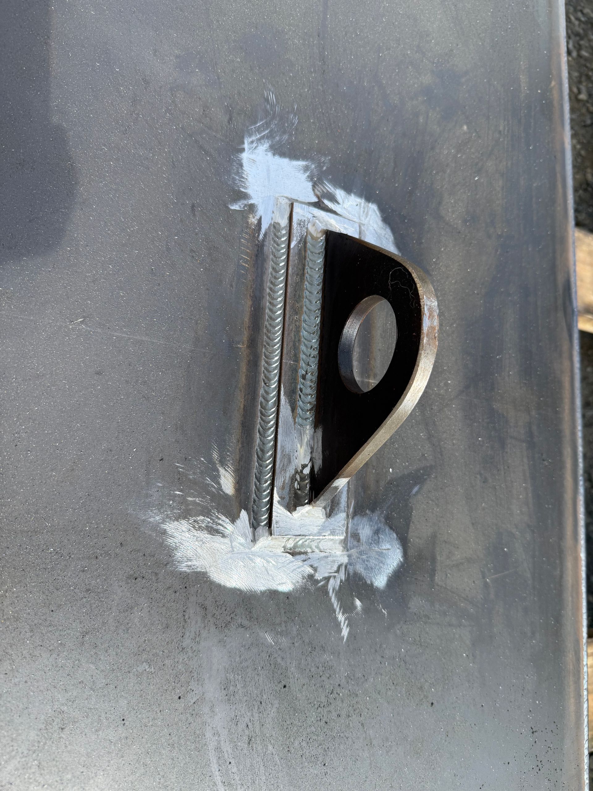 Close-up of a damaged metal latch with chipped paint and white scrape marks on a grey surface — Resurge Diesel & Fabrication Pty Ltd In Balnagowan, QLD