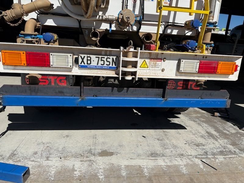 Rear of a truck with license plate XB-75N and blue rear under guard, parked on pavement — Resurge Diesel & Fabrication Pty Ltd In Balnagowan, QLD
