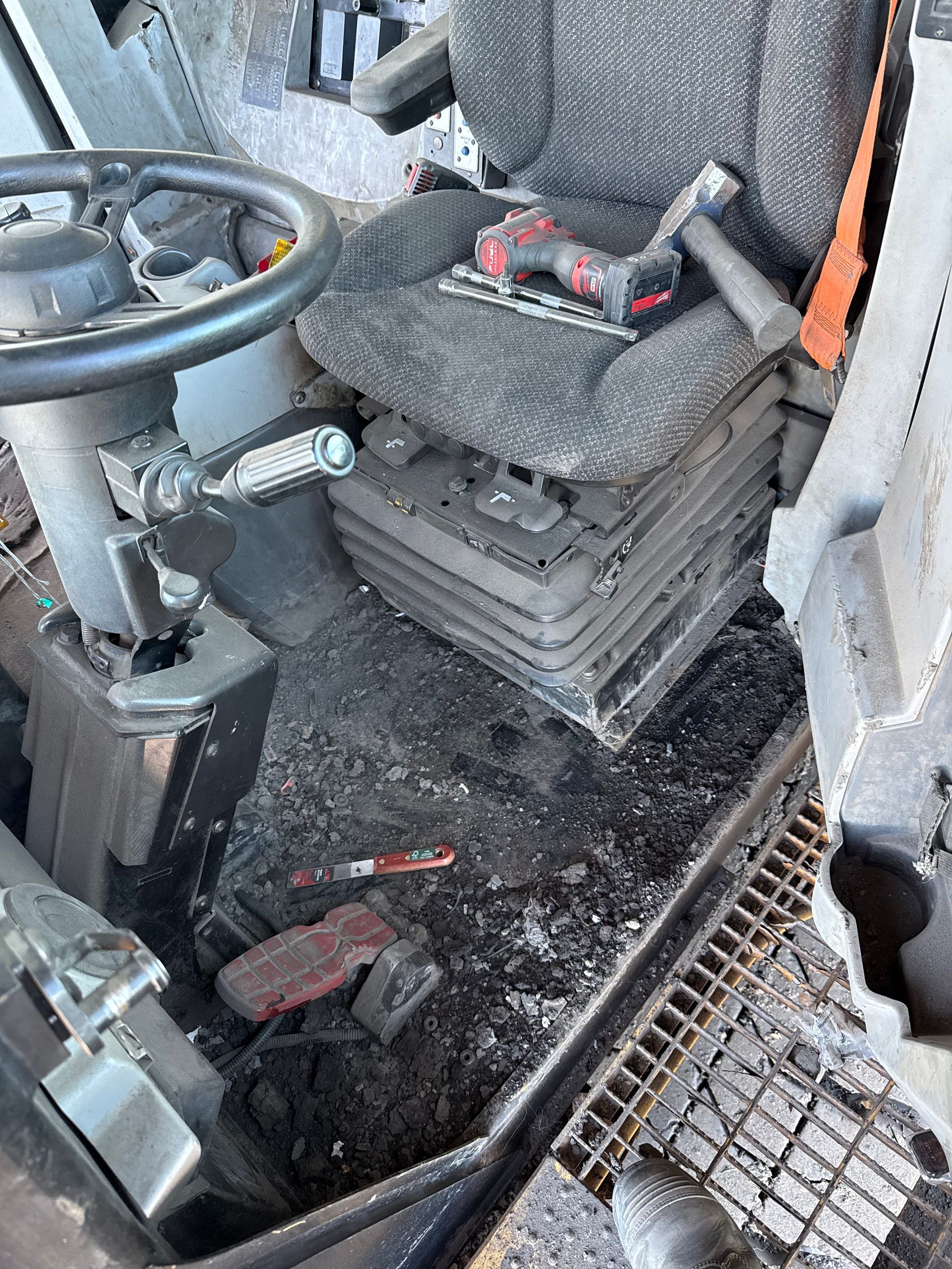 Damaged car interior with a torn seat, scattered debris, and a cracked floor mat near the steering wheel — Resurge Diesel & Fabrication Pty Ltd In Balnagowan, QLD