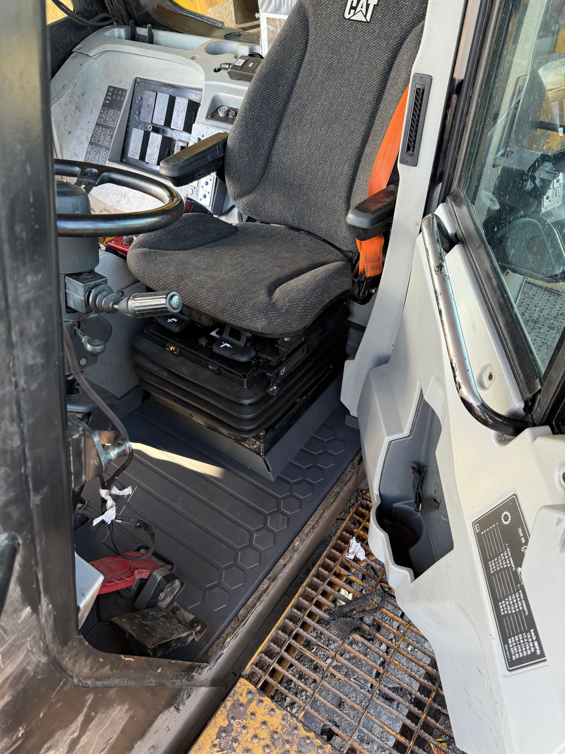 Inside a vehicle cab, a black driver’s seat beside the door and floor step area — Resurge Diesel & Fabrication Pty Ltd In Balnagowan, QLD