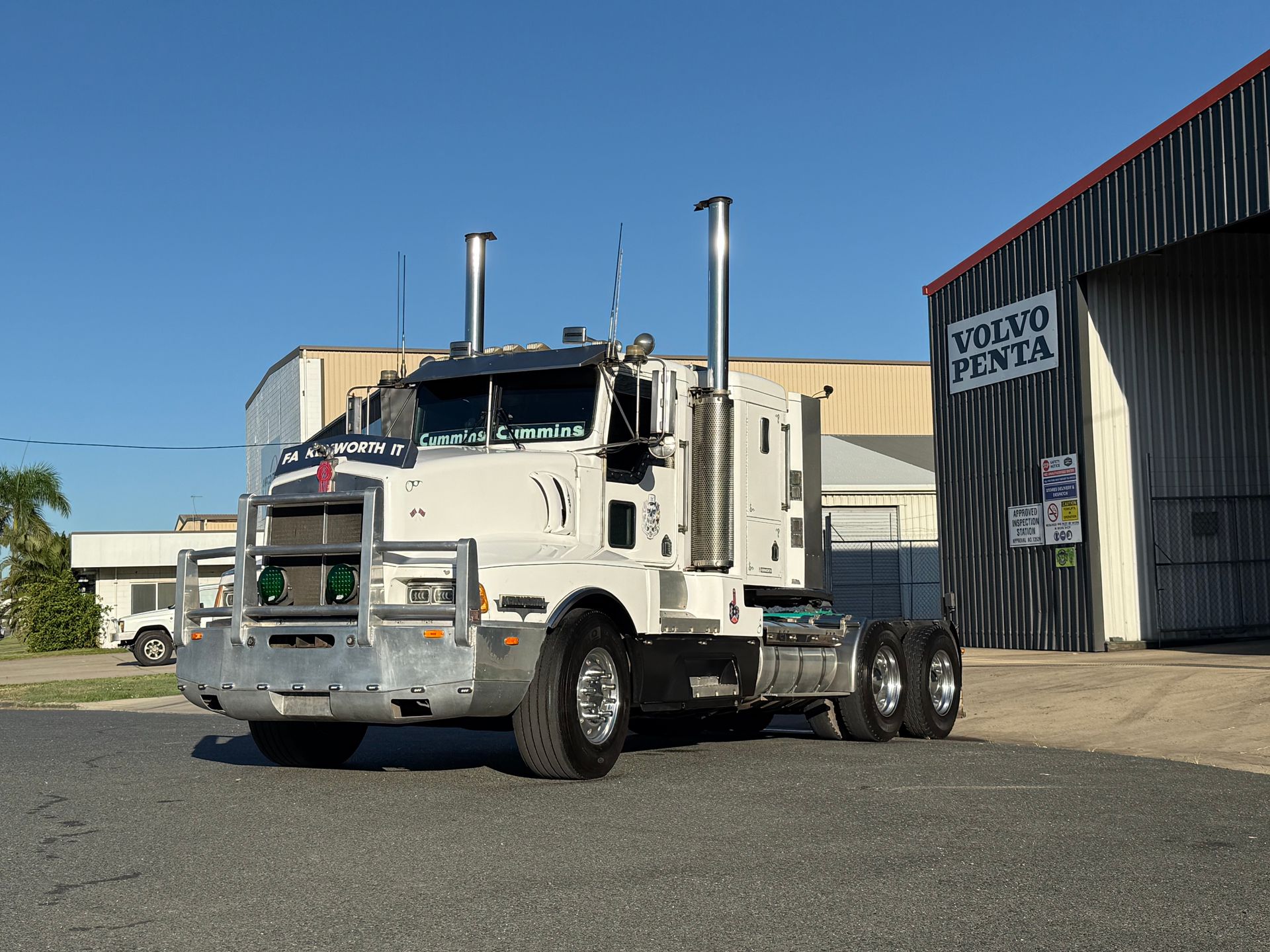 White semi-truck parked beside a corrugated metal building under a clear blue sky — Resurge Diesel & Fabrication Pty Ltd In Balnagowan, QLD