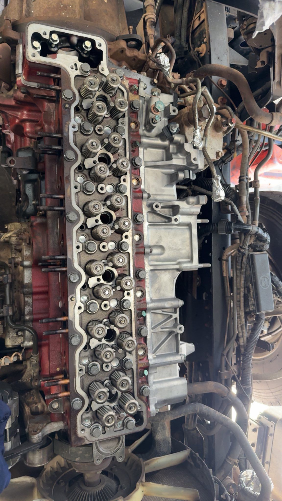 Partially disassembled engine block with exposed cylinders and hoses in a workshop — Resurge Diesel & Fabrication Pty Ltd In Balnagowan, QLD