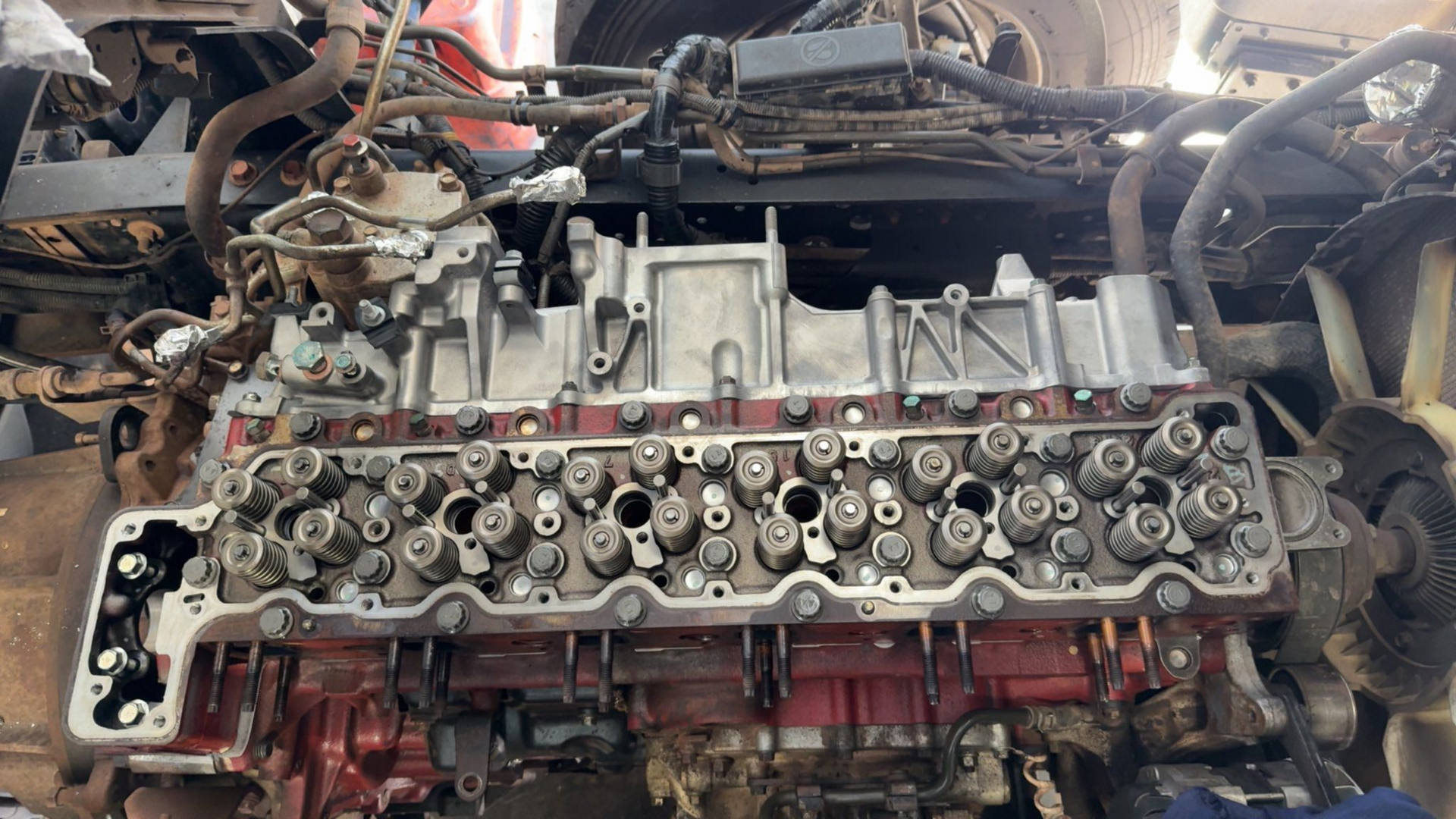 Car engine with exposed cylinder head and valve train in a partially disassembled engine bay — Resurge Diesel & Fabrication Pty Ltd In Balnagowan, QLD