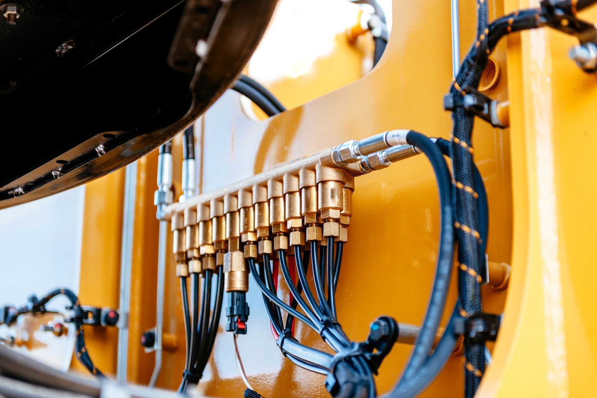 Close-up Of Hydraulic Lines And Fittings On A Yellow Construction Machine — Resurge Diesel & Fabrication Pty Ltd In Balnagowan, QLD