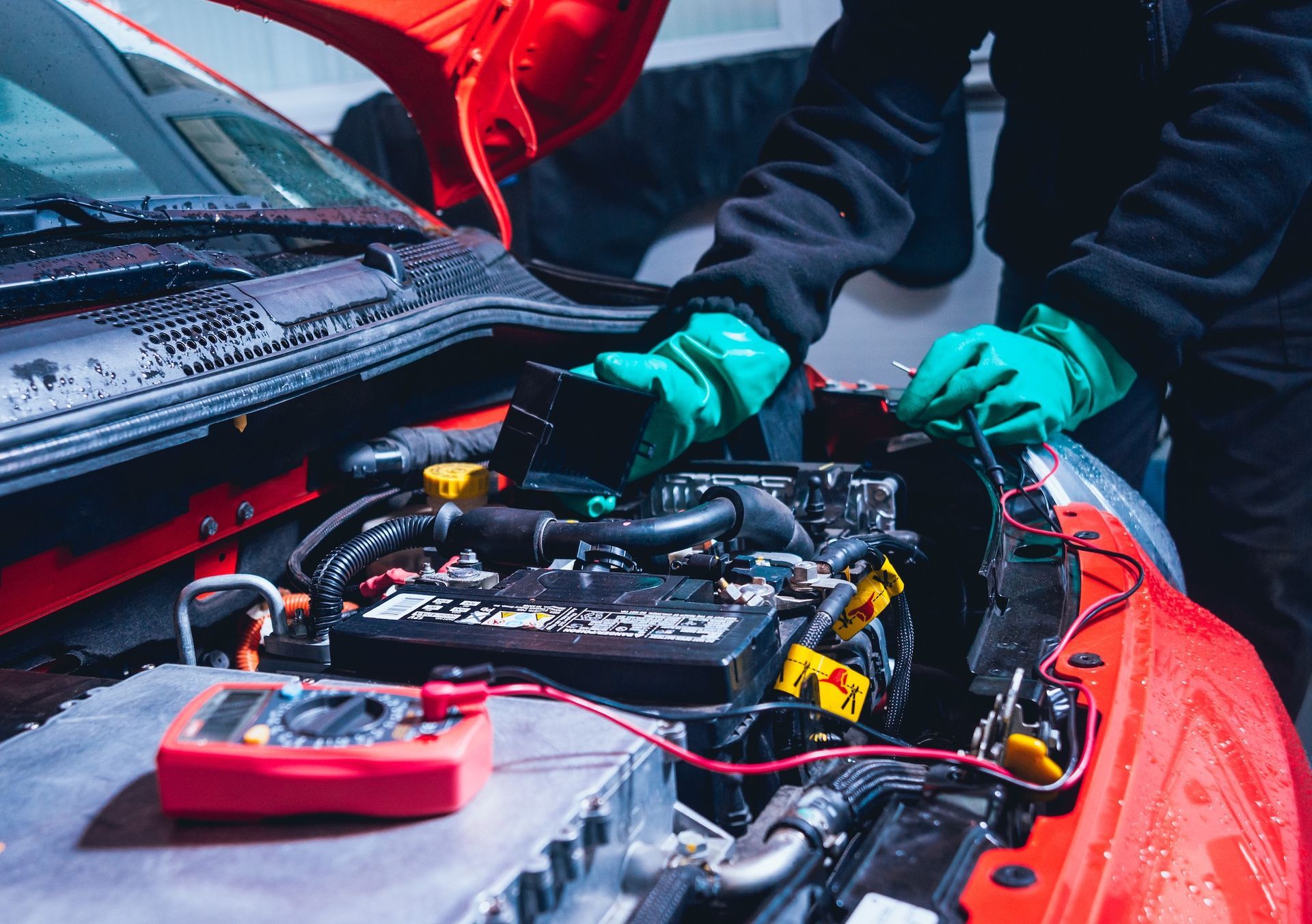 Person In Green Gloves Repairs Car Engine, Red Multimeter Visible — Resurge Diesel & Fabrication Pty Ltd In Balnagowan, QLD