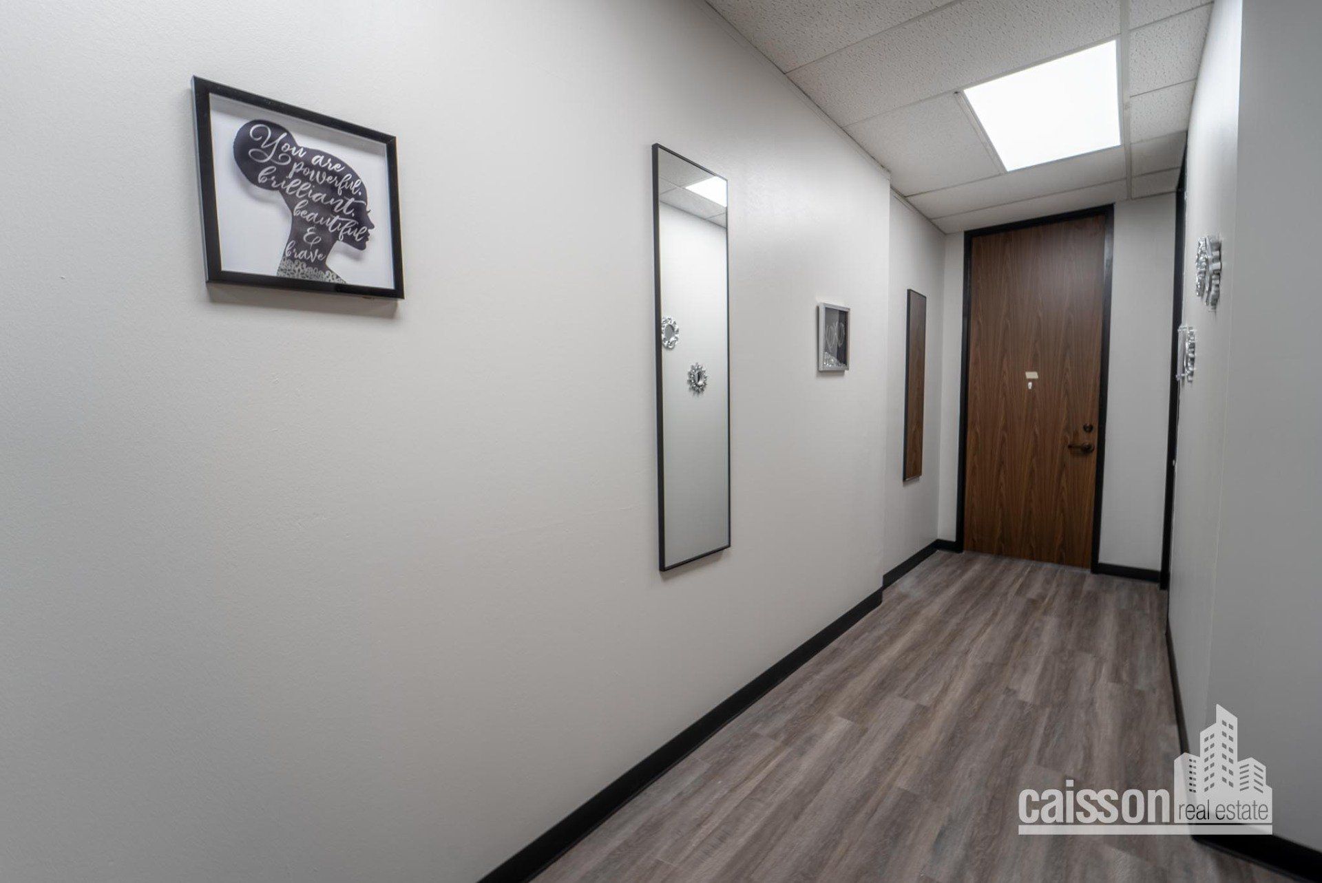 Interior view of hallway of suite with grey flooring.