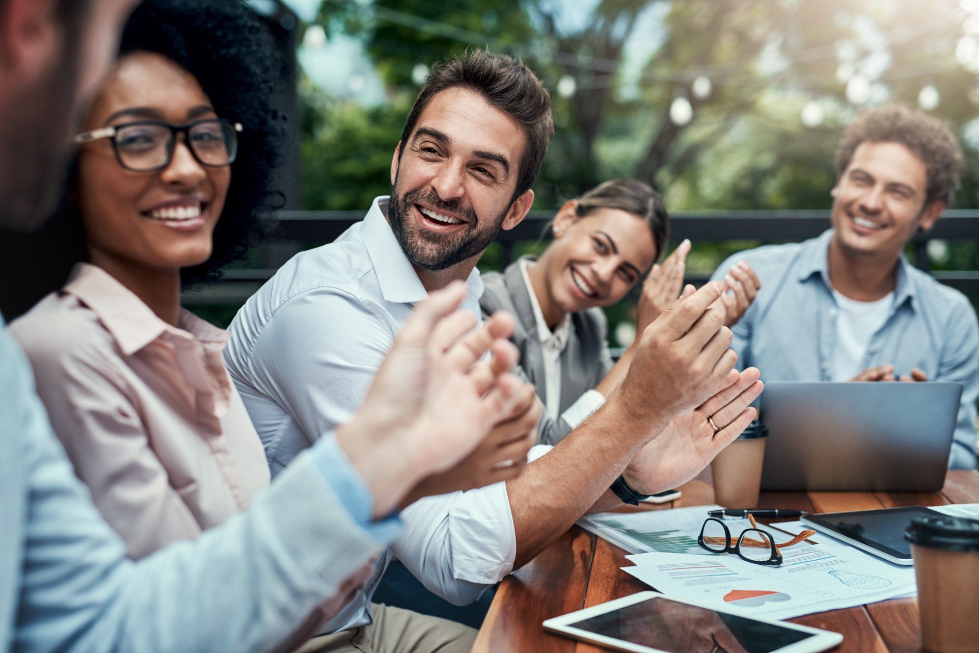 Happy group of co-workers at a meeting around a table