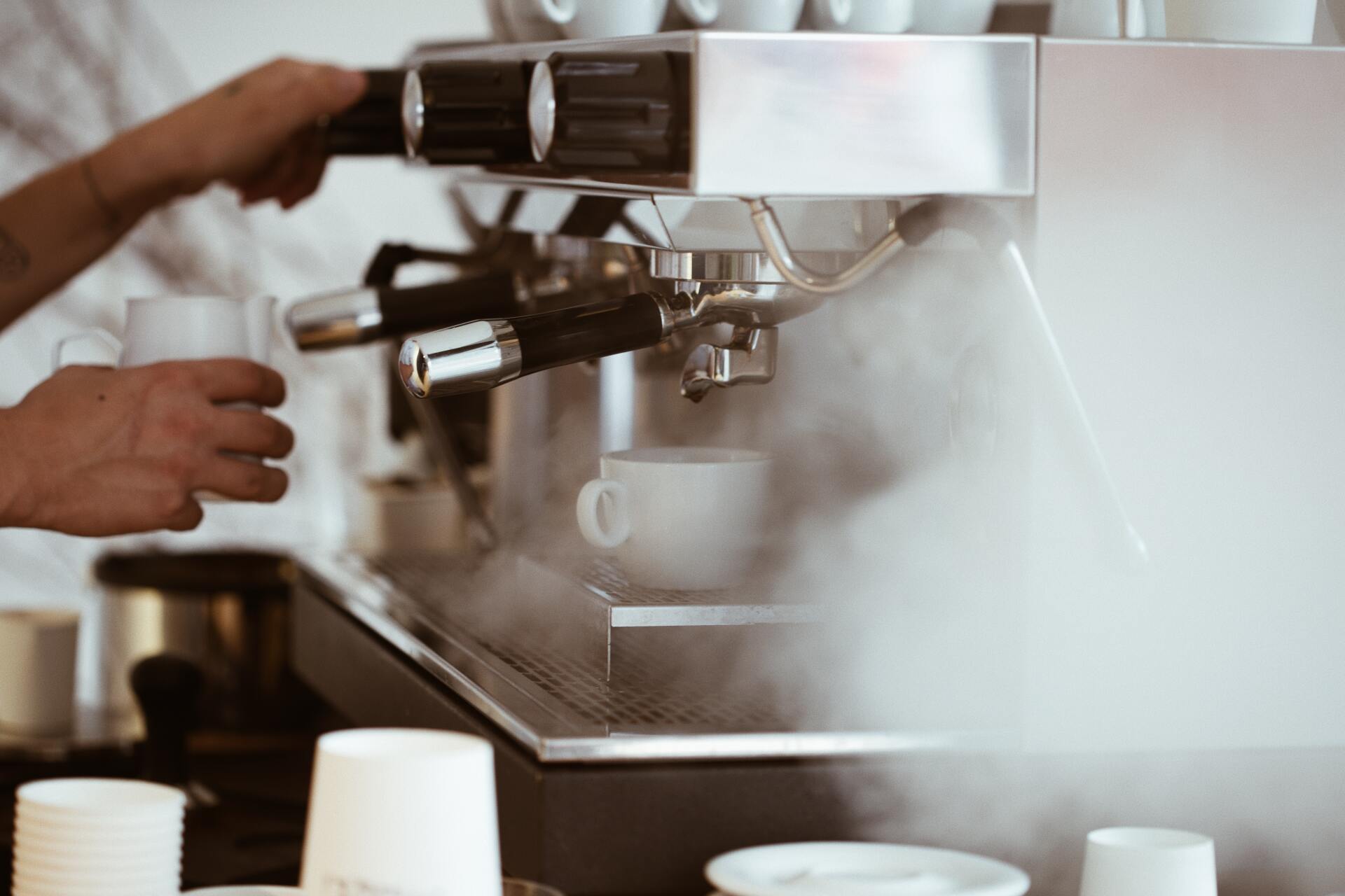 Barista making coffee with espresso machine.