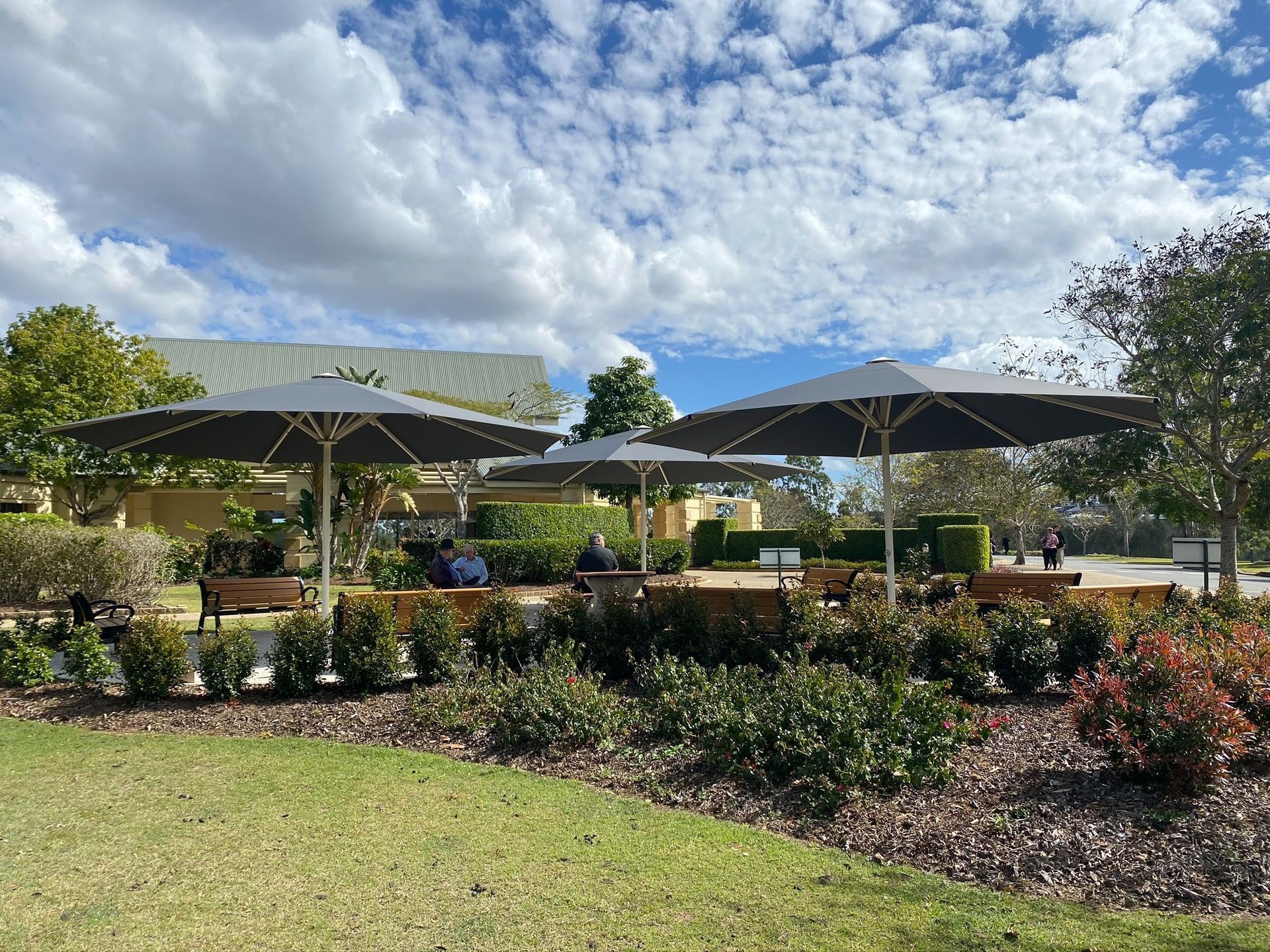 Six Meter Octagonal Umbrella Surrounded By Hedges And Tables — Shadetech in Alice in Ciccone, NT