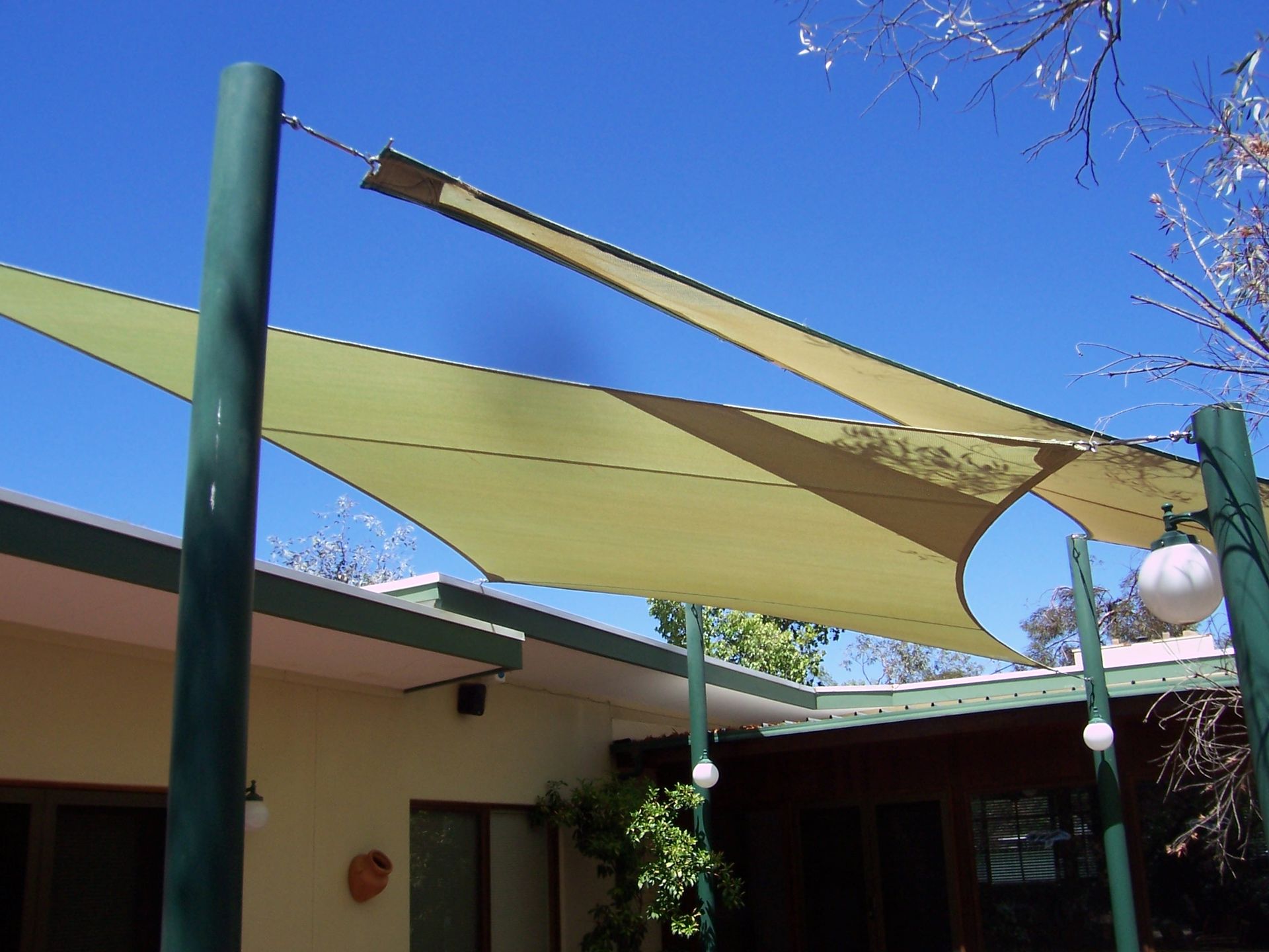 Two Yellow Shade Sails Over a Swimming Pool  — Shadetech in Alice in Ciccone, NT