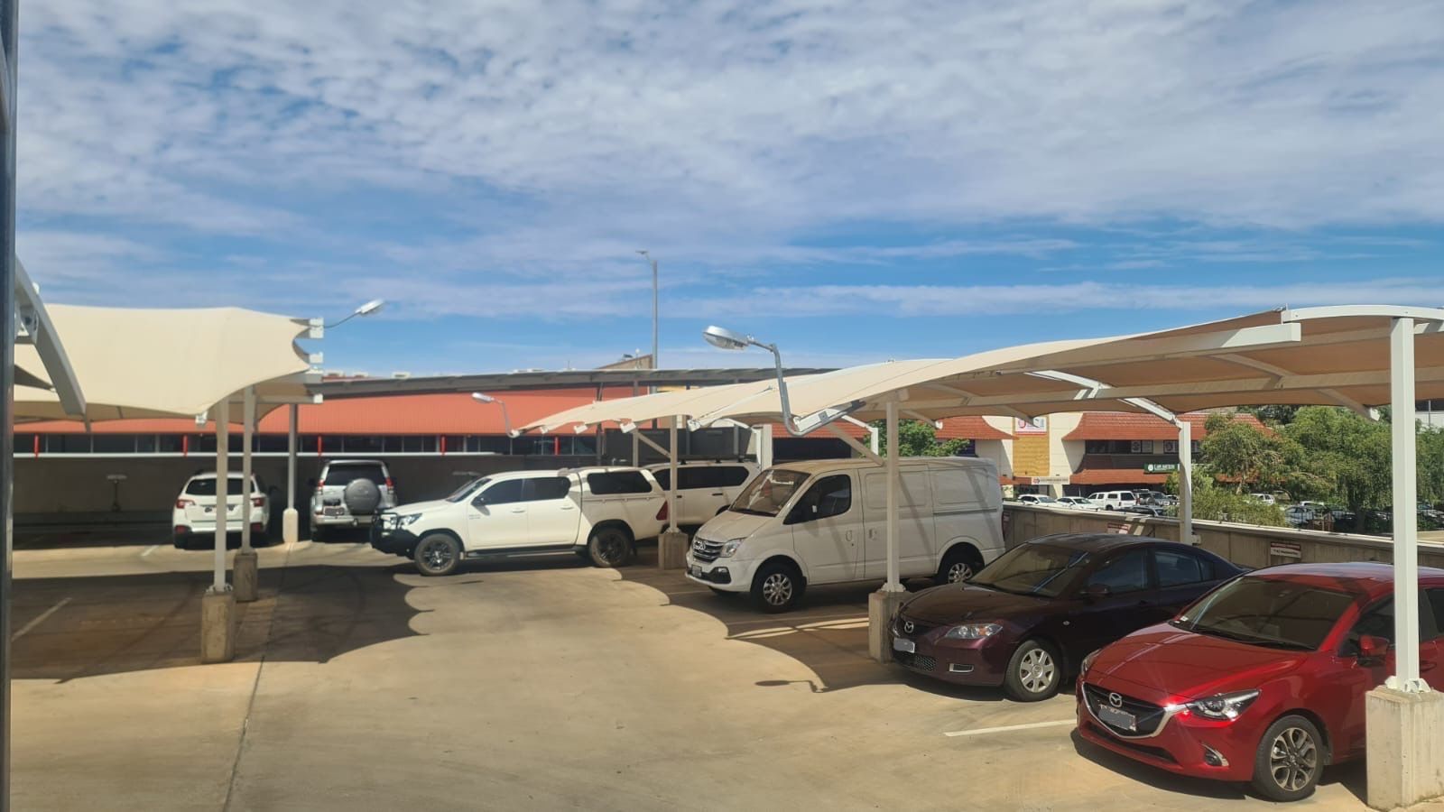 A Yellow Shade Sail over a Driveway — Shadetech in Alice in Ciccone, NT