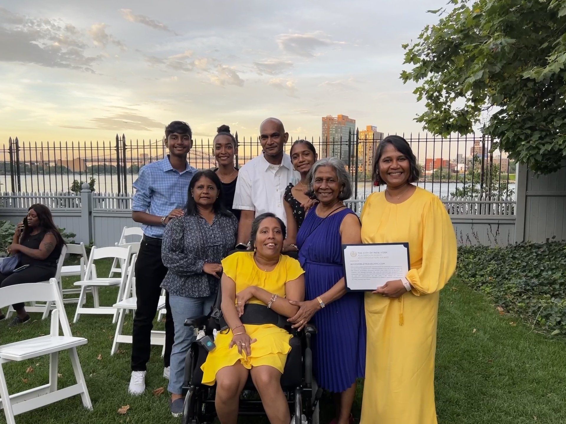We're all dressed up nicely with huge smiles at Gracie Mansion's outdoor gardens at sunset. 