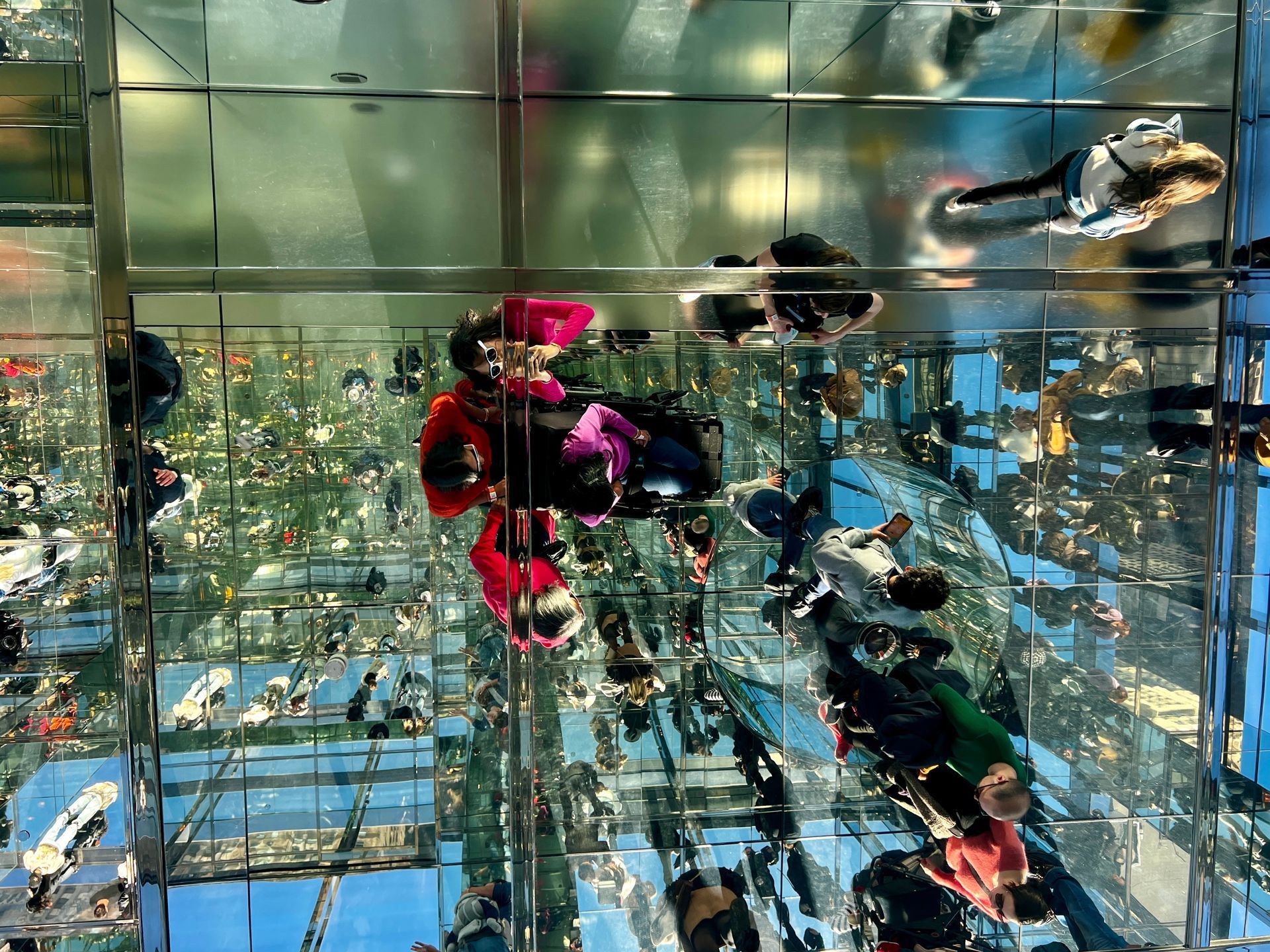 Photo is in daylight and the people aren't recognizable. It captures a surreal reality of the space akin to an Infinity Room.