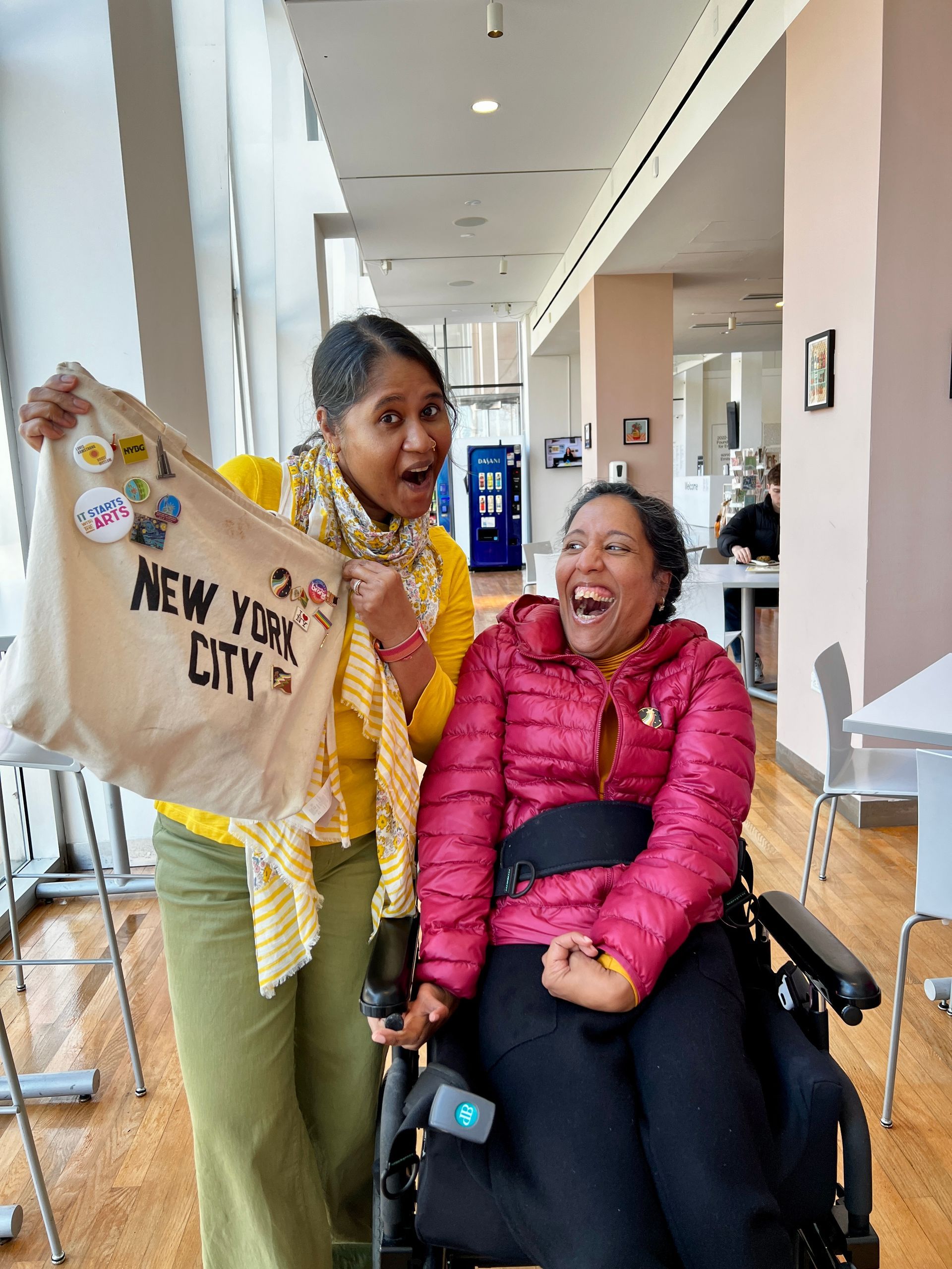 Annie and Lakshmee are siblings with an Indo-Caribbean heritage.  They are colorfully dressed and are joyful in this photo. 