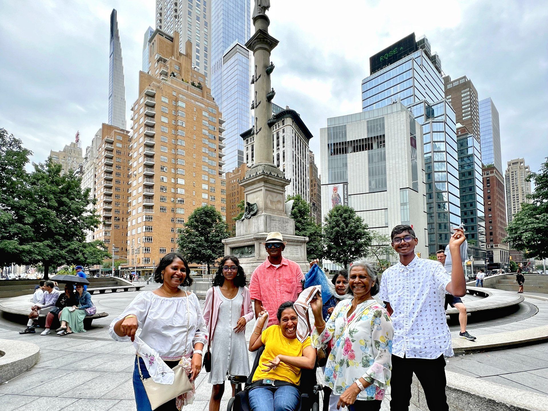 Our family at Columbus Circle dressed colorfully holding up our kerchiefs while waiting for the Jazz Procession.