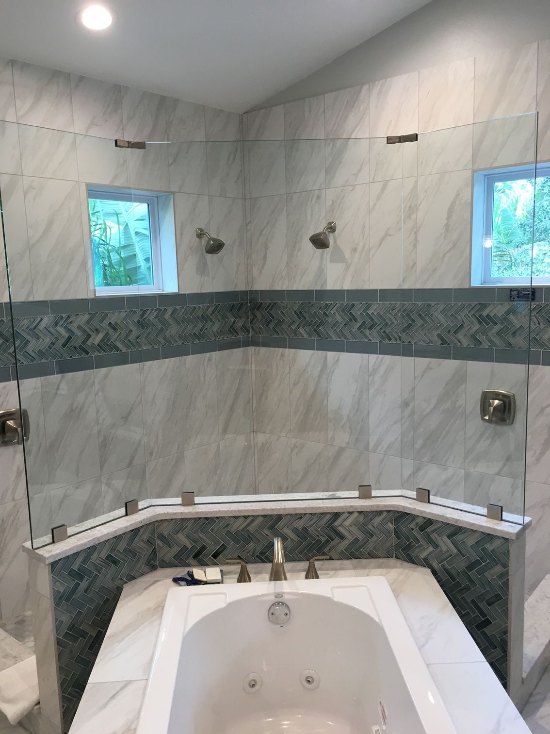 A bathroom with a tub, shower, and window.