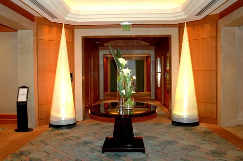 A hallway with a vase of flowers on a table