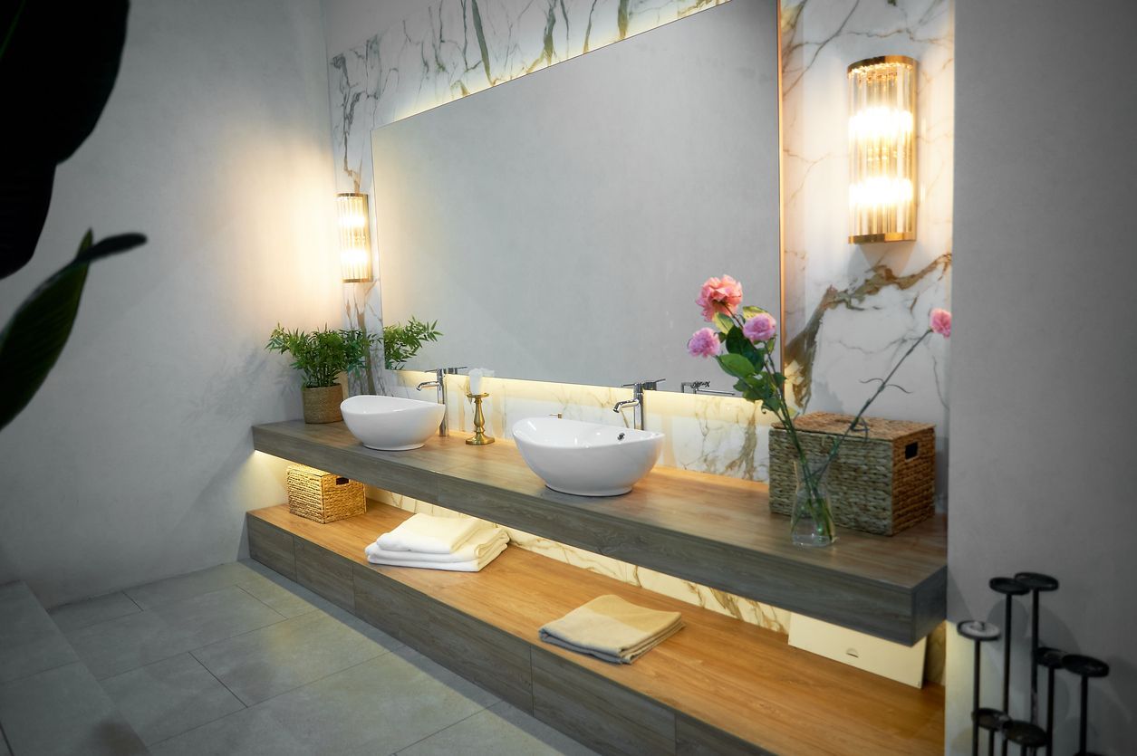 A bathroom with two sinks and a large mirror