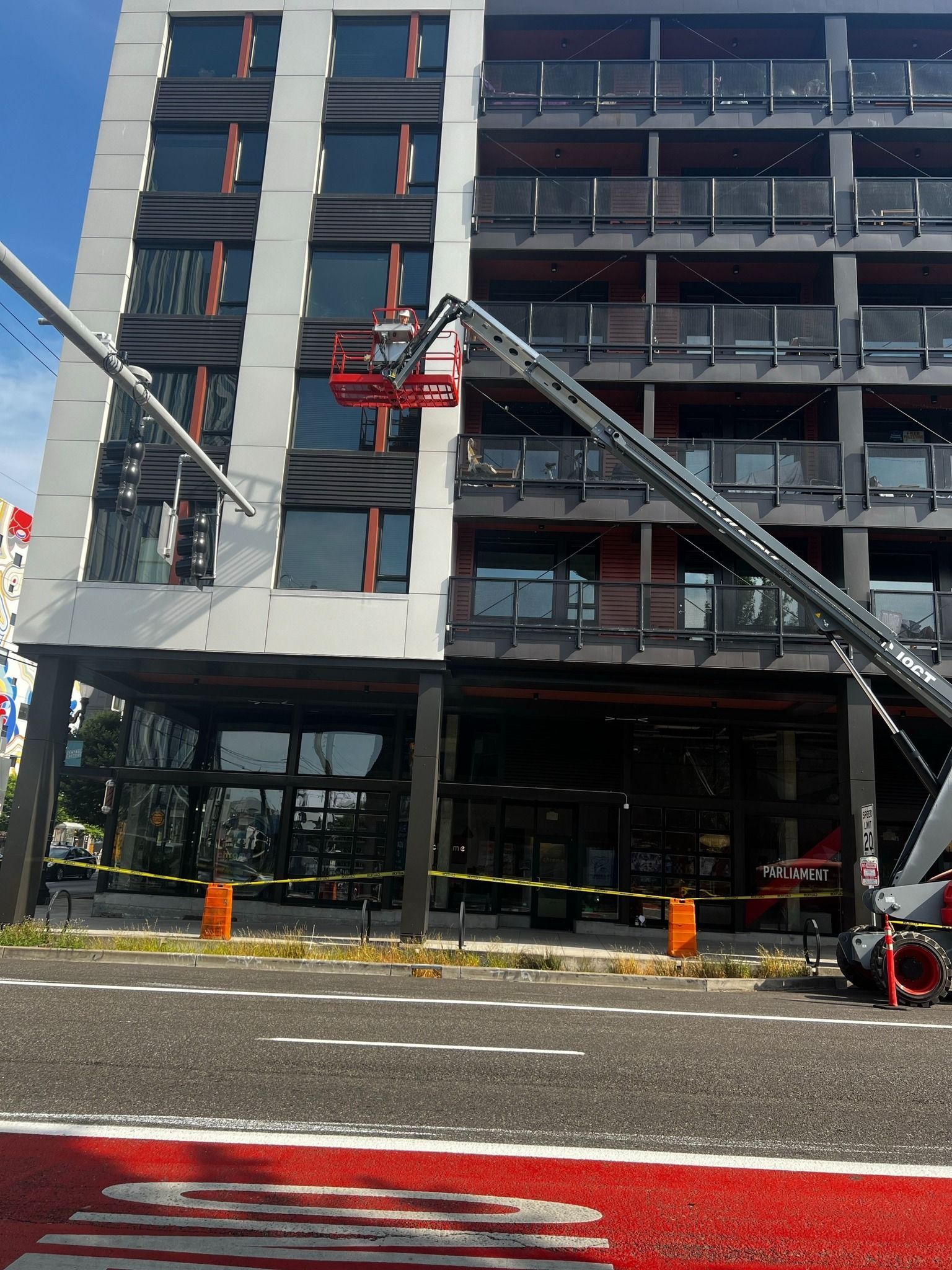 A ladder is being used to clean the windows of a building