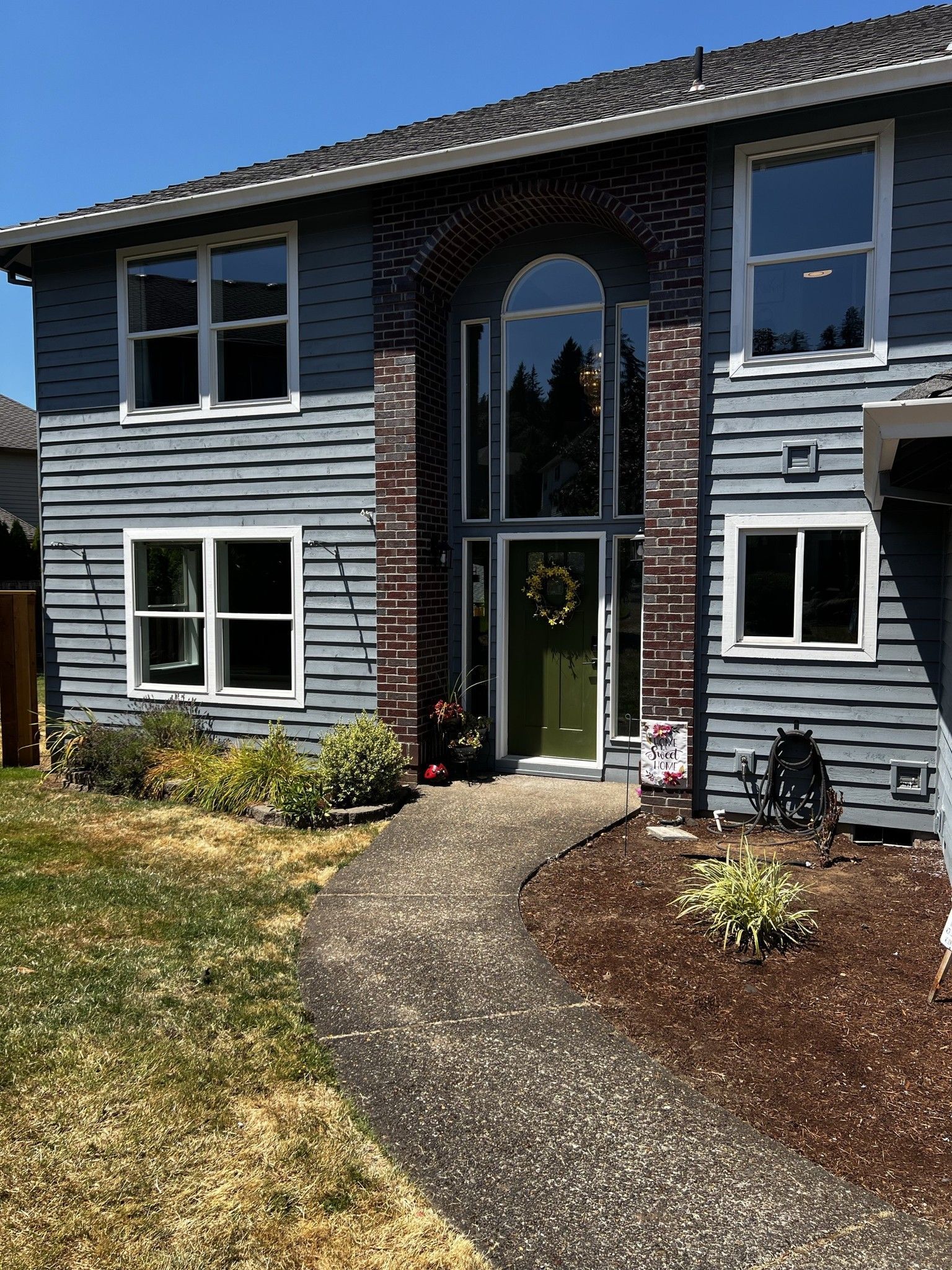 A large house with a lot of windows and a wreath on the door.