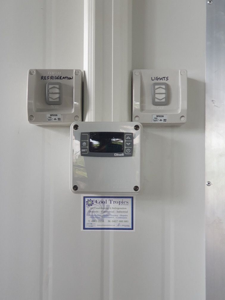 Three wall-mounted control boxes with labels