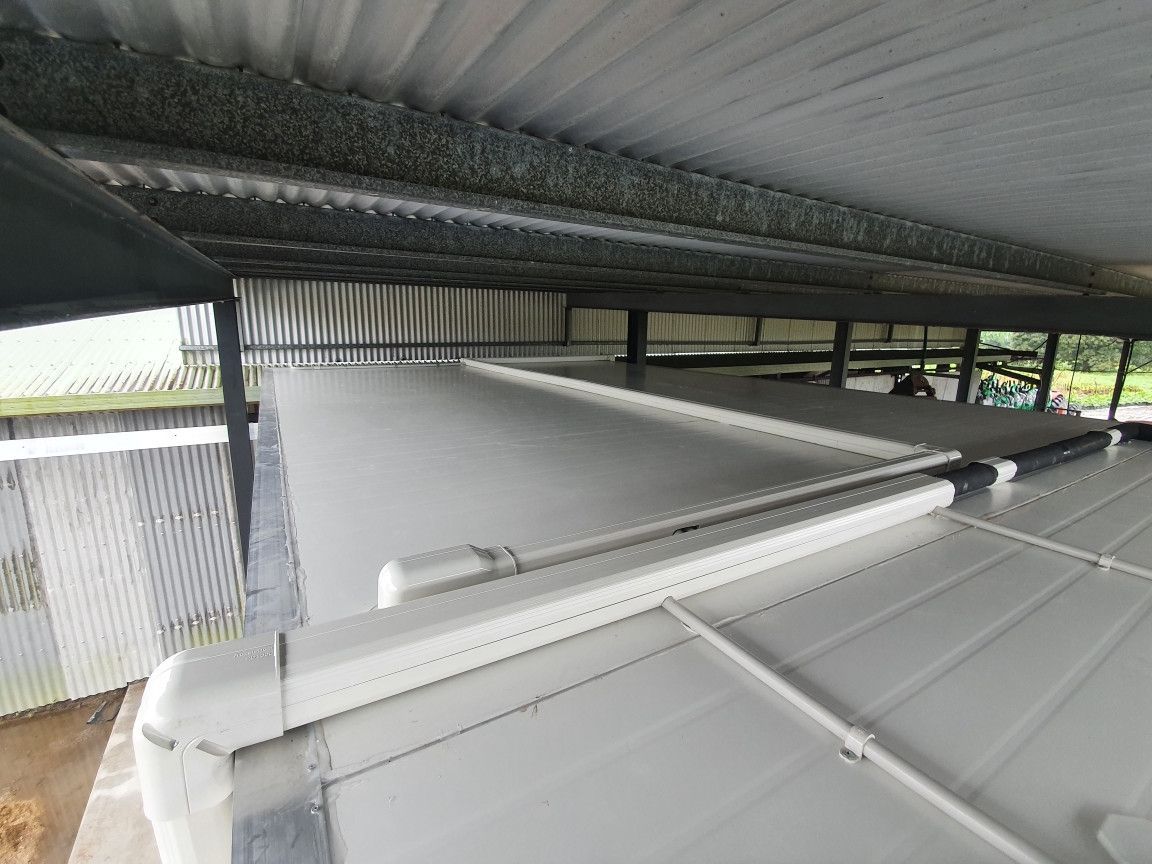 White rooftop with PVC pipes, under a corrugated metal roof.— Cool Tropics Air Conditioning & Refrigeration in Mission Beach, QLD