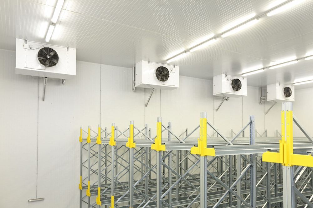 A Warehouse With a Lot of Shelves and Fans on the Ceiling — Cool Tropics Air Conditioning & Refrigeration in Tablelands, QLD