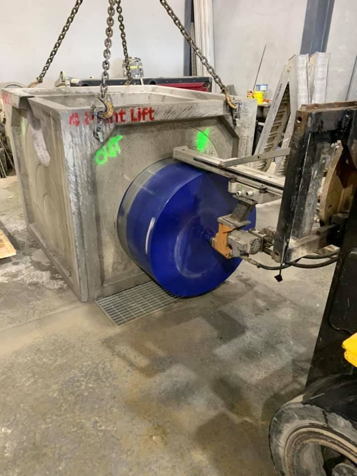 A large blue barrel is being lifted by a forklift — Newcastle Cut & Drill In Boolaroo, NSW