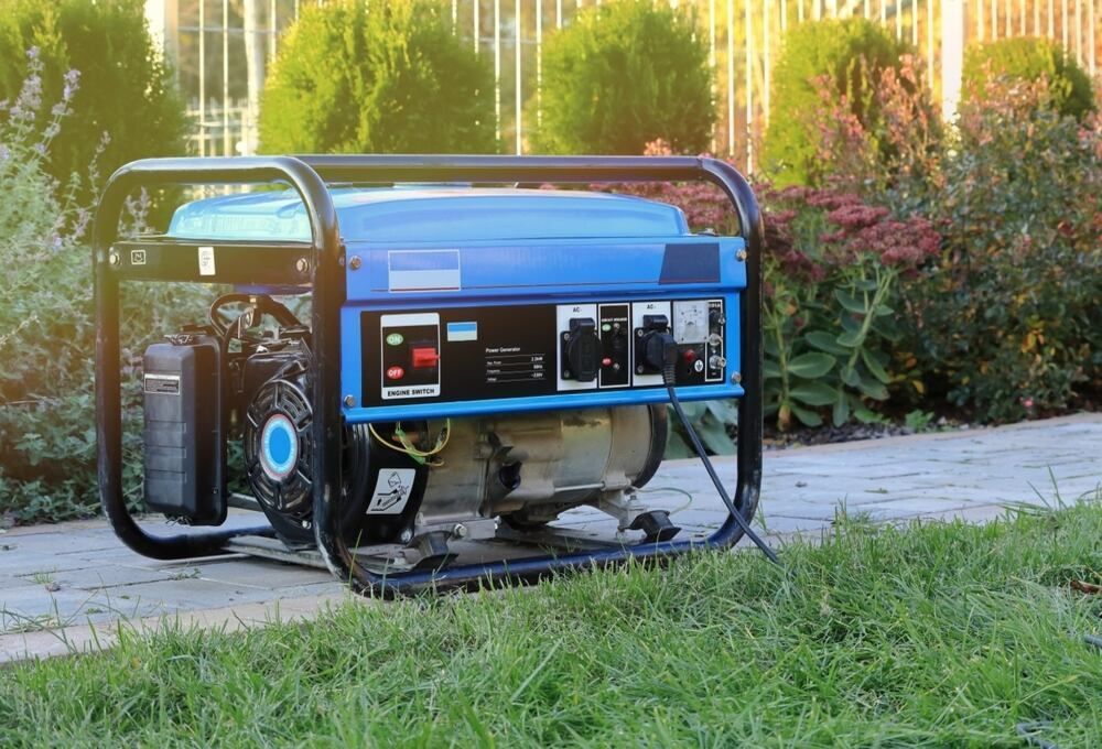 A Blue Portable Generator Is Sitting On Top Of A Lush Green Lawn — Newcastle Cut & Drill In Boolaroo, NSW