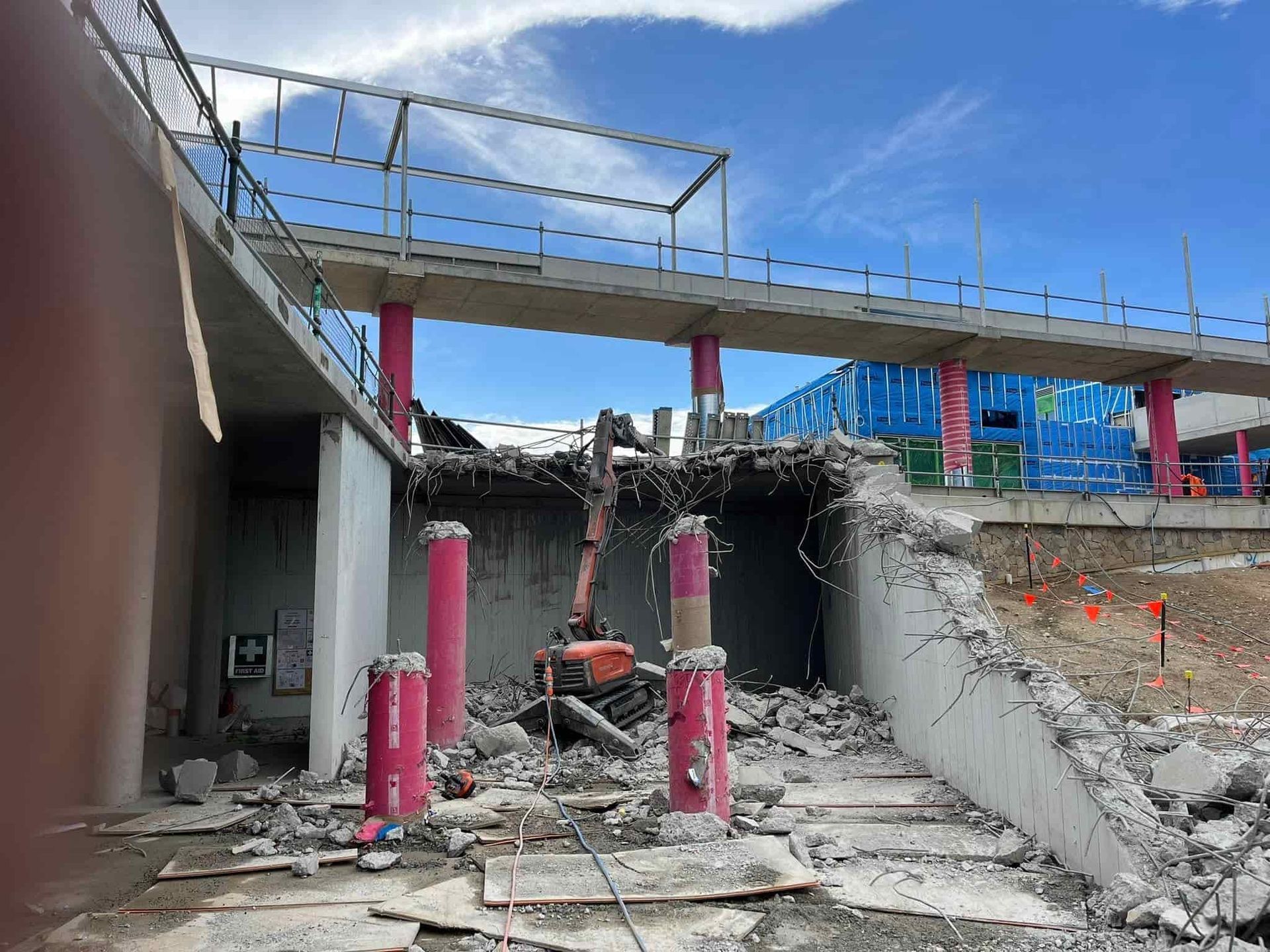 A building is being demolished with a bridge in the background — Newcastle Cut & Drill In Boolaroo, NSW