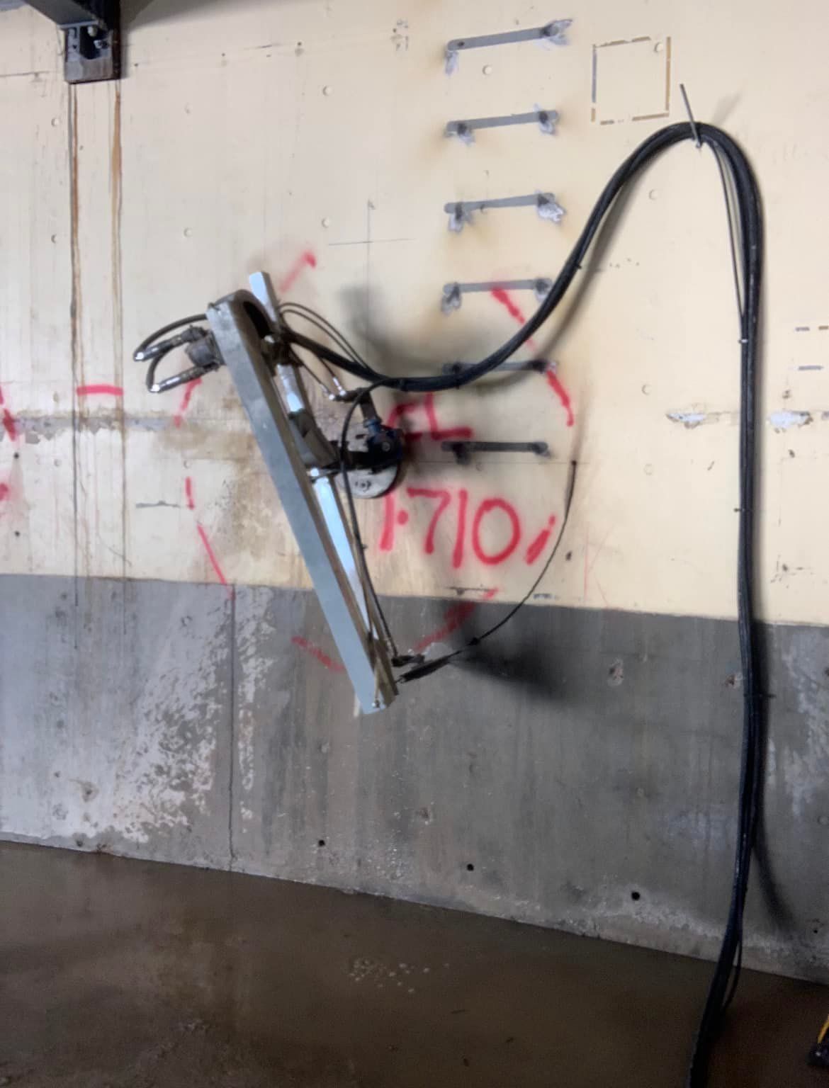 A hose is attached to a wall that says f710 on it — Newcastle Cut & Drill In Boolaroo, NSW