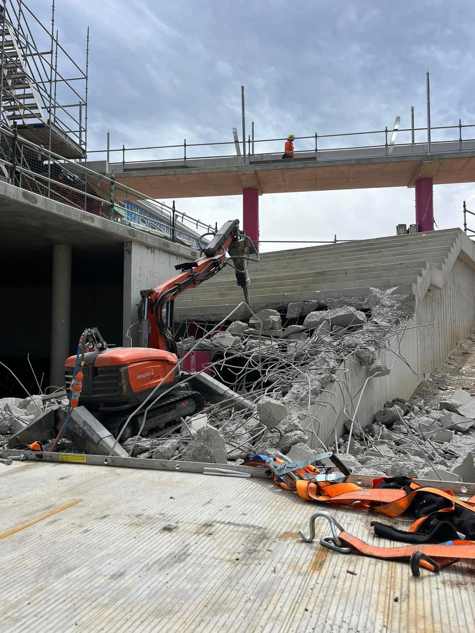 A large pile of concrete is being demolished by a bulldozer — Newcastle Cut & Drill In Boolaroo, NSW