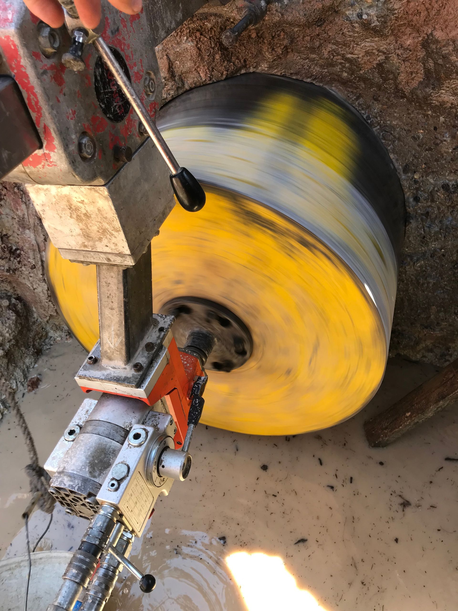 Using A Machine To Cut A Hole In The Floor Of A Building — Newcastle Cut & Drill In Boolaroo, NSW