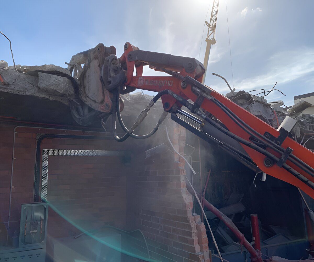 A Machine Is Cutting Through A Brick Wall — Newcastle Cut & Drill In Boolaroo, NSW