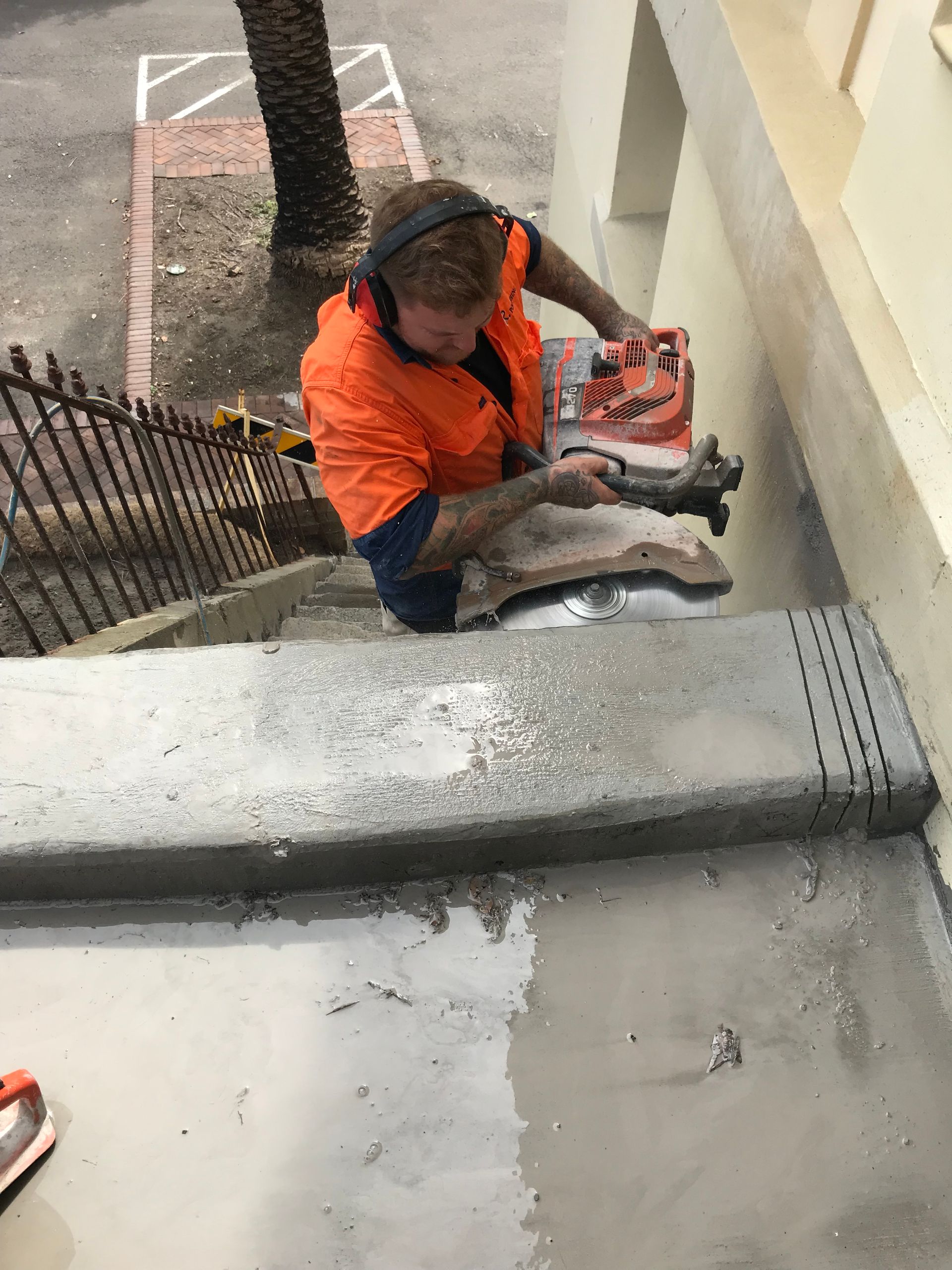 A person is using a circular saw to cut concrete. — Newcastle Cut & Drill In Boolaroo, NSW